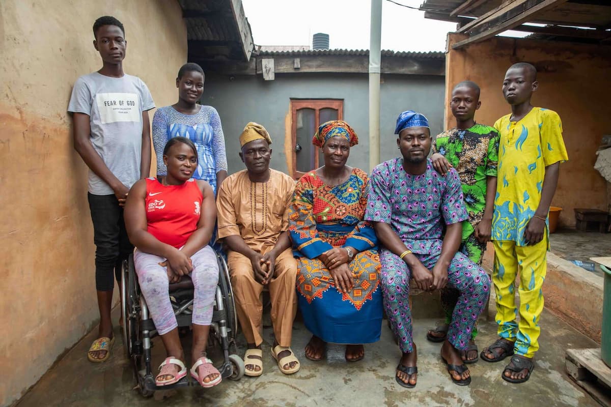 Olajumoke and her family, eight people in total, pose for a group photo in their home in Lagos.
